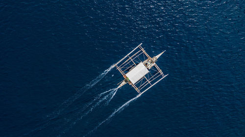 Aerial view of outrigger boat in sea