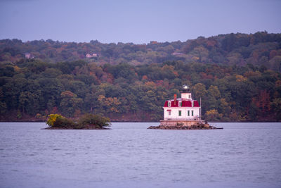 Scenic view of lake by building against clear sky