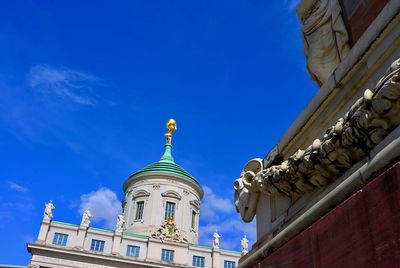 Low angle view of historic building against blue sky