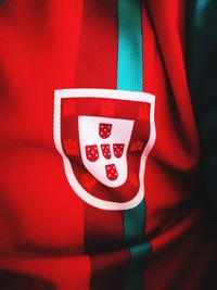 Close-up of heart shape hanging on red fabric