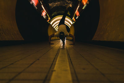 Rear view of man standing in tunnel