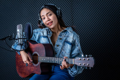 Young woman playing guitar