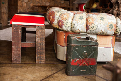 High angle view of old canister by stool at home