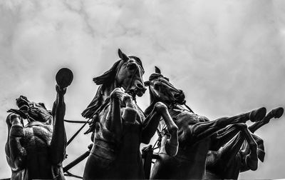 Low angle view of statue against sky