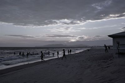 People on beach against sky