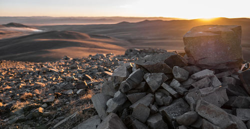 Close-up of rocks against sky during sunset