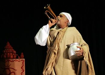 Low angle view of man playing bugle on stage