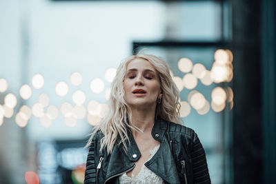 Portrait of beautiful woman against blurred background