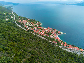 High angle view of townscape by sea