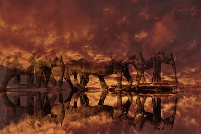 Panoramic view of fire on lake against sky during sunset