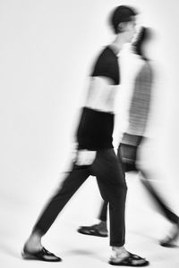 Blurred motion of people walking on wall