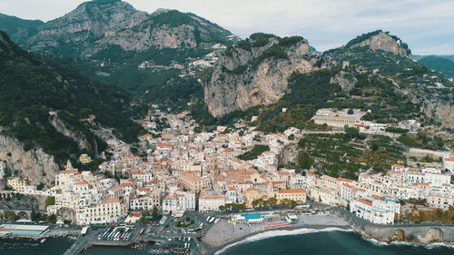 High angle view of townscape and mountains against sky