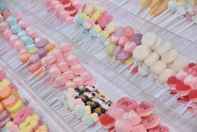 High angle view of various candies and lollipops for sale at market stall