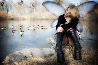 Young woman with horse in water