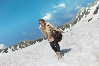 Portrait of woman standing on snow