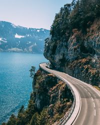 Road by sea against sky