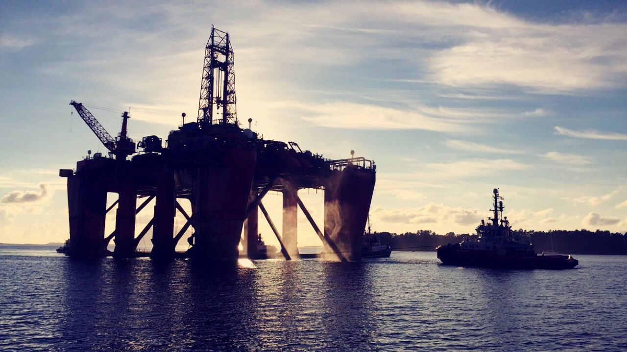 sea, water, sky, waterfront, nautical vessel, transportation, cloud - sky, mode of transport, sunset, silhouette, harbor, boat, built structure, cloud, commercial dock, crane - construction machinery, nature, mast, outdoors, ship