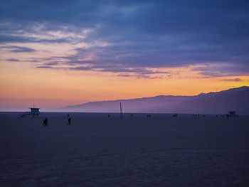 Scenic view of beach against sky during sunset
