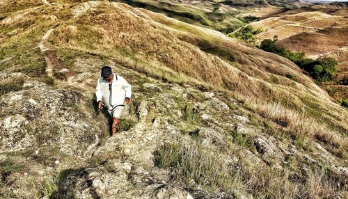 Rear view of man standing on rock