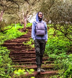 Rear view of man walking in forest