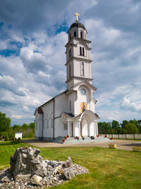 Church by building against sky