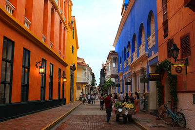 People on street in city against sky