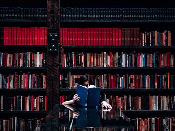 Woman reading book in the library