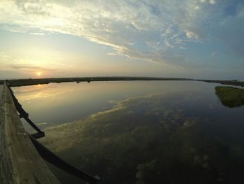 Scenic view of lake at sunset