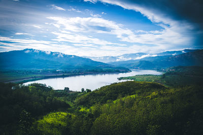Scenic view of lake against cloudy sky