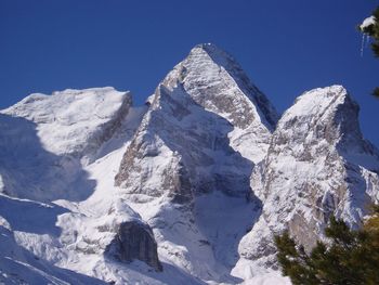 Scenic view of snowcapped mountains against clear blue sky