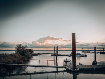 Scenic view of river against sky during sunset