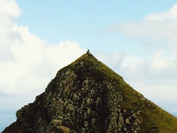 Low angle view of mountain against cloudy sky