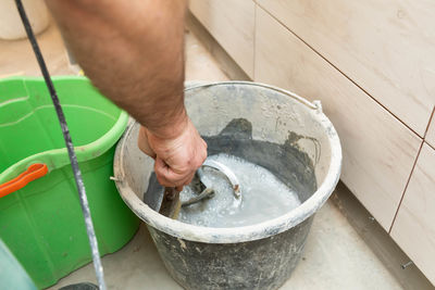 Low section of person washing hands