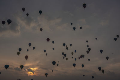 Low angle view of hot air balloons against sky during sunset