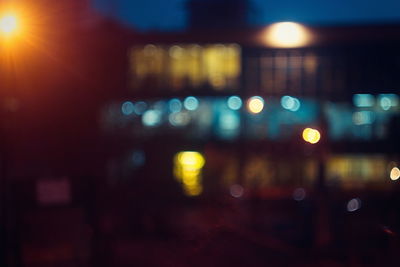 Defocused image of illuminated city street at night