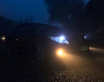 Illuminated car on road at night