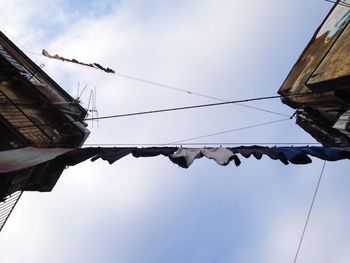 Low angle view of cables against sky