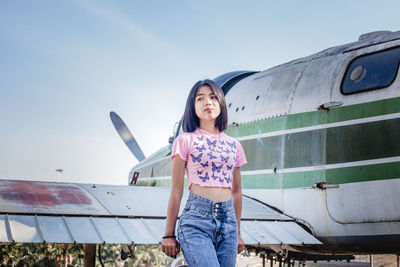 Portrait of happy woman standing against sky