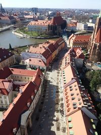 High angle view of cityscape by river against sky