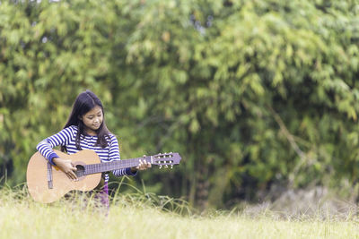 Full length of a girl playing on field