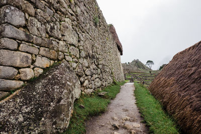 Panoramic shot of stone wall against sky