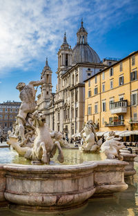 Statue of fountain against building