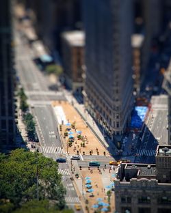 High angle tiltshift view of city street and flatiron building