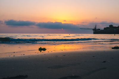 Scenic view of beach against sky during sunset