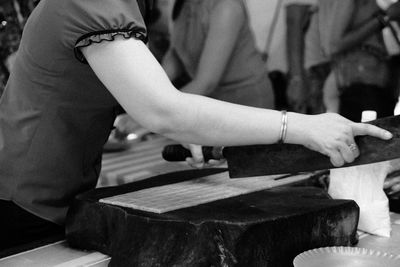 Midsection of woman playing piano