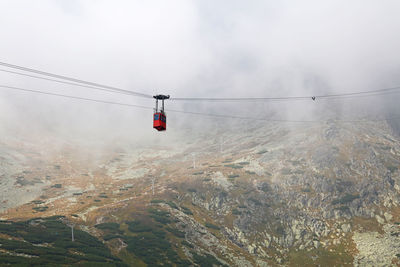 Low angle view of cable car against lomnicky peak