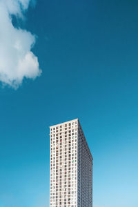 Low angle view of skyscrapers against blue sky