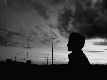 Silhouette in man standing against sky