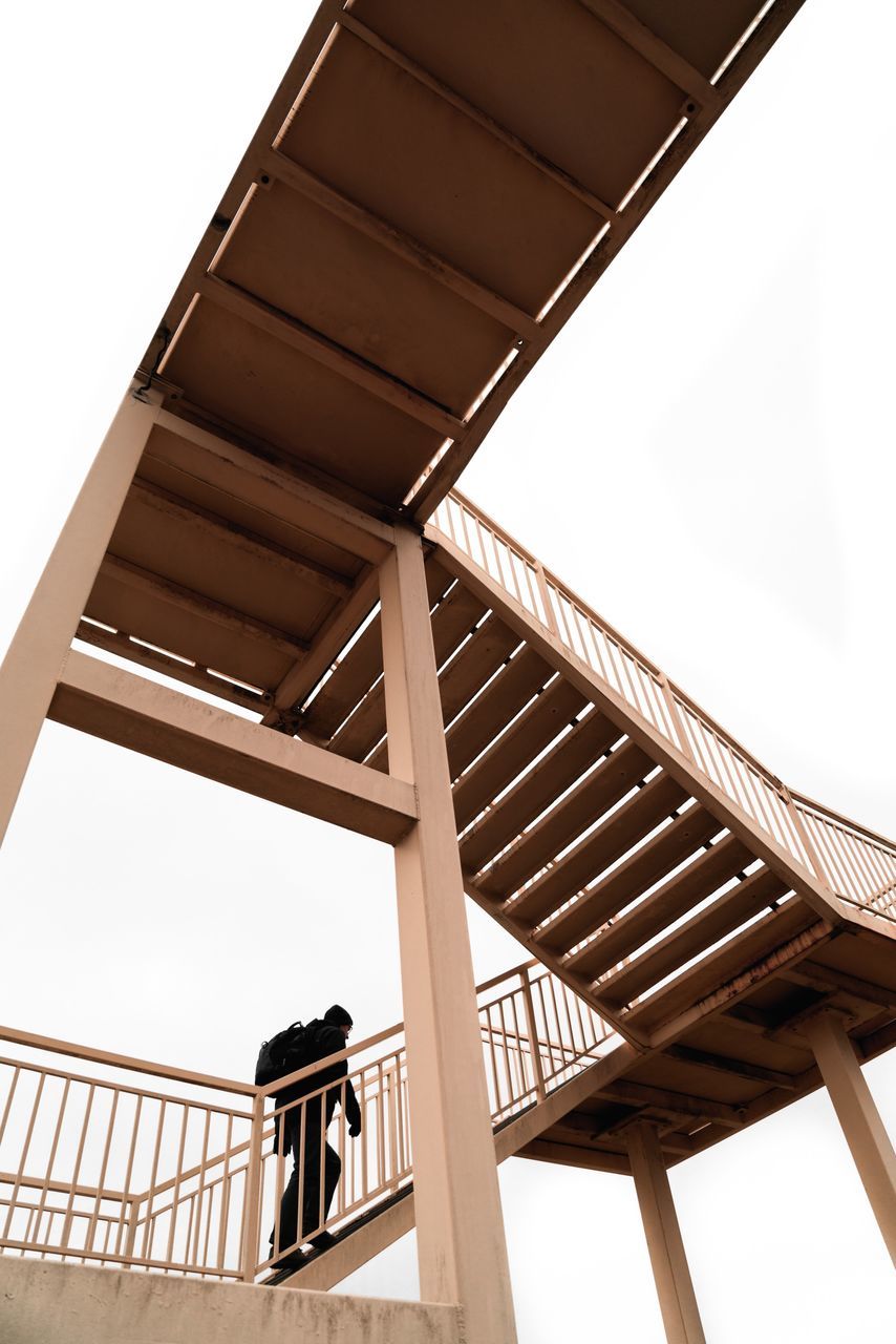 architecture, built structure, low angle view, sky, railing, clear sky, no people, day, nature, indoors, staircase, metal, pattern, connection, steps and staircases, bridge, bridge - man made structure, transportation, directly below, ceiling