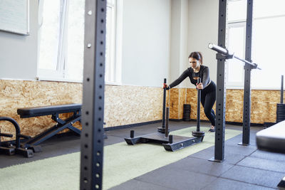 Side view of man exercising in gym